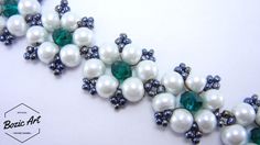 two pieces of jewelry with pearls and emeralds on them, sitting next to each other