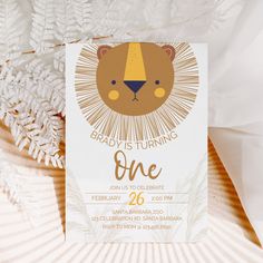 a lion birthday party is set up with white paper and gold foil on the edges