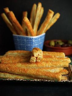 some bread sticks are stacked on a plate