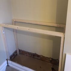 an unfinished shelf in the corner of a room