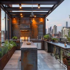 an outdoor kitchen is lit up with candles and potted plants on the counter top