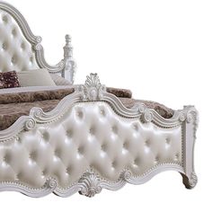 a white bed with an ornate headboard and foot board is shown against a white background