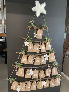 a christmas tree made out of burlocks and paper bags with tags hanging from it