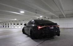 a black car parked in a parking garage