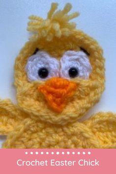 a crocheted yellow bird with big eyes