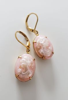 Rose engraved crystals with hidden design. Embedded in a polished gold frame. Luxury Vintage Pink Earrings, Vintage Pink Earrings, Luxury Gold Cameo Jewelry, Gold-tone Oval Elegant Jewelry, Gold Cameo Jewelry For Evening, Elegant Cameo Jewelry For Anniversary, Elegant Oval Gold-tone Jewelry, Elegant Cameo Earrings For Wedding, Gold Cameo Earrings For Wedding