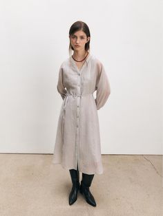 This Sheer Layered Dress offers a contemporary take on the classic long dress, featuring a sheer overlay that adds a touch of whimsy and sophistication. Its full button-down design allows for versatile styling options, while the sheer long sleeves give a light, airy feel to the garment. - Crafted with a lightweight fabric, the dress is perfect for layering and creates an elegant silhouette.- The sheer elements of the dress provide a subtle allure, making it suitable for both day and evening wear.- Long sleeves and a mid-calf length combine to offer coverage while maintaining a sense of grace and style.- This dress can be dressed up with heels for a formal event or paired with flats for a casual, yet chic look. Classic Long Dress, Layered Dress, Sheer Overlay, Evening Wear, Lightweight Fabric, 2 Colours, Mid Calf, Formal Event, Long Dress