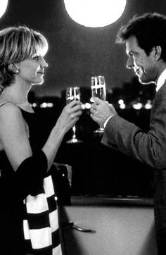 a man and woman toasting with wine glasses