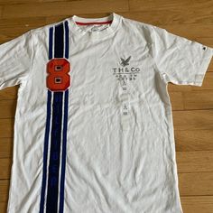 Nwt. Boys Large (12-14). Cotton. White With Textural Embroidered Front. Embroidered On Sleeve. Beautiful, New, Never Used. Tommy Hilfiger Graphic Print T-shirt For Streetwear, Tommy Hilfiger Sporty T-shirt With Graphic Print, Tommy Hilfiger Sporty Graphic Print T-shirt, Tommy Hilfiger Graphic Tee For Streetwear, Tommy Hilfiger Graphic Tee With Graphic Print, Tommy Hilfiger White T-shirt With Graphic Print, Sporty Tommy Hilfiger Tops With Graphic Print, Tommy Hilfiger Graphic Print Tee, Tommy Hilfiger White Crew Neck Top