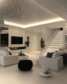 a modern living room with white furniture and stars on the ceiling, along with stairs