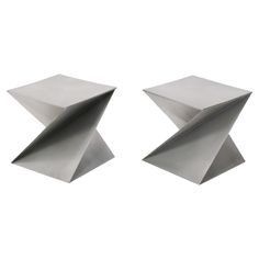 two metal sculptures sitting on top of each other