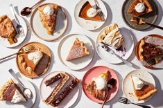 a table topped with lots of different types of pies and pie slices on plates