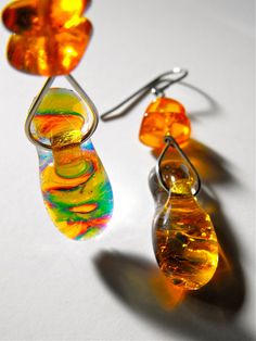 "This pair of earrings is just one in a collection of one-of-a-kind fused dichroic glass earrings created by Bryan Northup. Using techniques originated over years of working with fused glass, each pair is a one-of-a-kind, hand-wired adornment that displays a wide variety of vivid color combinations that change color in differing light conditions. This listing is for the pair pictured. Check out my other designs in the shop.   A variety of lengths are available but most are 1\", 1.5\" up to 2\" long glass pieces plus the ear wire   Each earring is wired by hand and in some cases augmented with accent beads.  The ear wire is either surgical steel or sterling silver See all photos for a full description. Handmade by Bryan Northup Objects are stored in a clean, non-smoking space.  Made in Oak Yellow Fusion Earrings For Gifts, Yellow Fusion Style Earrings For Gift, Iridescent Glass Earrings For Gift, Art Jewelry Earrings, Fused Glass Panel, Dichroic Glass Jewelry, Dichroic Glass Earrings, Art Glass Jewelry, Character Flaws