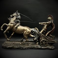 a statue of a man riding on the back of a horse next to a woman