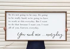 a person holding up a sign that says, you and me everyday so it's not going to be easy