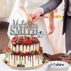 a newly married couple cutting their wedding cake with the words mr and mrs on top