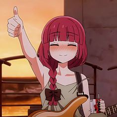 a girl with red hair holding a guitar and giving the thumbs up