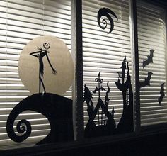 the silhouettes of halloween characters are on the window sill in front of the blinds