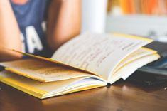 an open book sitting on top of a wooden table