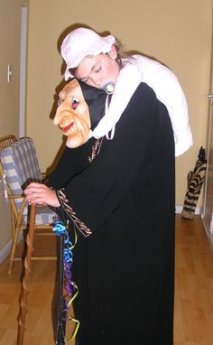 a woman dressed as a nun with a mask on her face and holding a cane