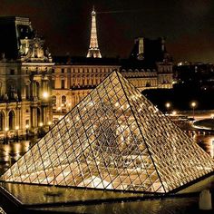 the glass pyramid is lit up at night