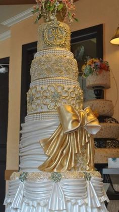 a wedding cake with gold and white decorations