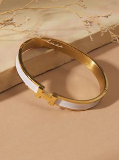 Embrace timeless elegance with this delicate gold bangle. This bracelet will make a cherished addition to your everyday style. Altar'd State Jewelry, Fall School, Bow Bracelet, Bangles Making, Stacked Jewelry, Bangle Designs, Gold Bangle, Cross Bracelet, Girly Jewelry