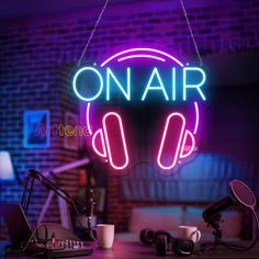 a neon sign that says on air with headphones