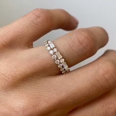 a woman's hand with a diamond ring on it