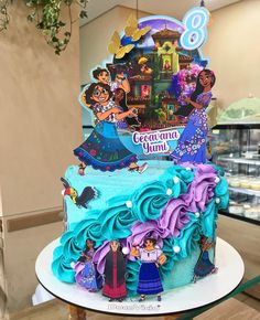 there is a birthday cake decorated with princesses and characters on the top tiers