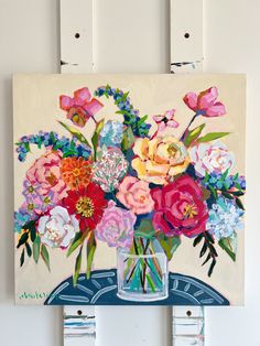 a painting of flowers in a vase on a wall