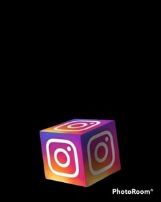 a photoboom cube with the instagram logo on it is lit up in the dark