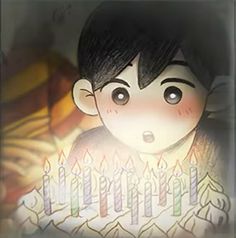 a young boy holding a birthday cake with lit candles in front of him and looking at the camera