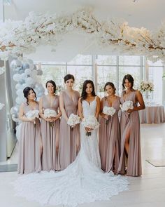 the bride and her bridesmaids are posing for a photo in front of balloons