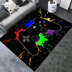 a living room area rug with a video game controller on the floor and paint splatters all over it