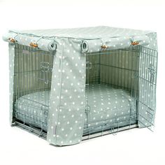 a dog crate cover with white polka dots on it