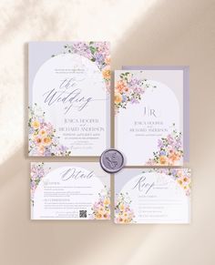 three wedding cards with flowers on them and a wax seal in the middle, sitting next to each other