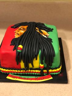 a cake decorated with raspberries and dreadlocks