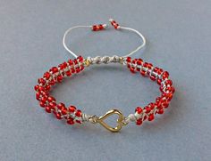 Red Seed Bead Heart Bracelet, Valentines Day Bracelet, Tiny Macrame Bracelet, Gift For Her The Bracelet is made by me with seed beads in red color, gold tone metal heart and light grey synthetic satin cord. ❥It is perfect as a gift to a friend or someone you love. SIZES: --------- Metal heart: 15 mm x 9 mm Width of Bracelet: 6 mm Synthetic Satin Cord: 0.9 mm Seed Beads: 2 mm Adjustable size in length with a sliding spiral macrame knot. Expands from 15 to 26 cm. Let me know if you need a differen Adjustable Heart Beads Bracelet For Jewelry Making, Red Macrame Bracelet Jewelry, Bohemian Red Heart-shaped Bracelet, Bohemian Bracelets With Heart Beads For Valentine's Day, Bohemian Heart Beads Bracelets For Valentine's Day, Bohemian Heart Beads Bracelet For Valentine's Day, Adjustable Beaded Heart Friendship Bracelets, Adjustable Heart-shaped Beaded Friendship Bracelets, Bohemian Beaded Bracelets With Heart Beads For Valentine's Day