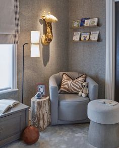 a child's room with a giraffe head on the wall