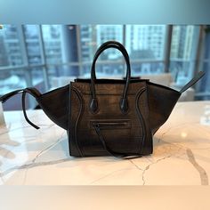 Rare Edition From The Fall 2015 Collection By Phoebe Philo. The Celine Phantom Luggage Tote Is One Of The Most Sought After Bags. Featuring A Casual Yet Luxurious Style, It Is Simple And Distinctive With Its Sturdy Handles And Detailed Stitching. This Medium Phantom Luggage Tote Features The Distinctive Wings And Braided Zipper Pull In Super Rare Stamped Crocodile Leather With Silver Hardware. Leather Interior, One Zip Pocket Internally And Externally. Details Handle Drop: 5.25" Height: 11" Width: 12" / Width: 23" L (With Wings) Depth: 11” 100% Authentic Or Money Back. Includes Dust Bag The Exterior Leather Is In Excellent Condition, Minor Scratches On The The Front Left Side Of Bag Modern Black Bags With Crocodile Pattern, Modern Black Shoulder Bag With Crocodile Pattern, Modern Black Crocodile Pattern Shoulder Bag, Designer Black Crocodile Pattern Bag, Black Textured Leather Shoulder Bag For Everyday Luxury, Everyday Luxury Black Textured Leather Shoulder Bag, Designer Black Shoulder Bag With Crocodile Pattern, Luxury Black Bags With Crocodile Pattern, Luxury Black Crocodile Pattern Bag