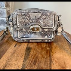 Like New In Excellent Condition This Purse Is Beautiful!! Soft Snakeskin Pattern Leather - Has Some Powder Make Up Small Marks Inside, Other Than That This Bag Looks Brand New 5.5” X 7” X 3” Strap Drop 21” Silver Crossbody Shoulder Bag With Silver-tone Logo, Silver Crossbody Shoulder Bag With Branded Hardware, Silver Coach Shoulder Bag For Evening, Coach Silver Shoulder Bag With Branded Hardware, Coach Silver Bag With Gunmetal Hardware, Chic Silver Coach Shoulder Bag, Silver Coach Bags With Gunmetal Hardware, Coach Silver Evening Bag, Silver Coach Evening Bag