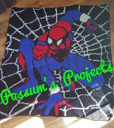 a crocheted spiderman blanket with the words procusum's projects on it