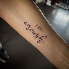 a woman's arm with the words i am grateful tattooed on her left forearm