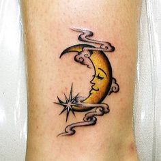 a tattoo on the leg of a woman with a crescent moon and stars in it