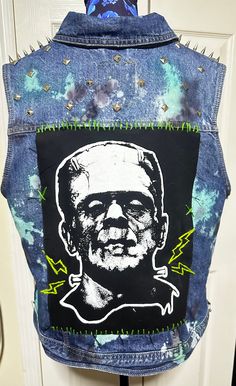 a jean jacket with an image of a man's face on it