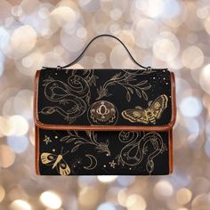 "► ABOUT THIS PURSE Colors: Black, gold Design: snake, moths, flowers, stars The design is printed on all sides. The handle and trim are brown. The purse comes with a black strap. If you prefer a vegan brown strap, select that upgrade option before checking out. * Made from high-grade waterproof canvas, durable, water-resistant. Rigid purse. * Can be used as a nice laptop iPad storage bag, business briefcase, college school bag, leisure travel tote bag, crossbody messenger bag, card wallet case, Gothic Brown Bag For Everyday Use, Gothic Brown Bag, Adjustable Clutch Bags As Gifts, Adjustable Clutch Bag As Gift, Adjustable Crossbody Bag As Gift, Gothic Crossbody Shoulder Bag For Gift, Gothic Crossbody Shoulder Bag As Gift, Gift Bags With Detachable Strap, Goth Bag