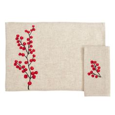 two place mats with red berries on them