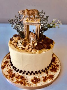 a cake decorated with chocolate and leopard figurines