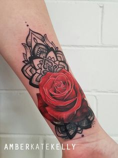 a red rose tattoo on the left arm